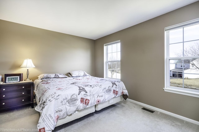 bedroom featuring visible vents, carpet flooring, and baseboards