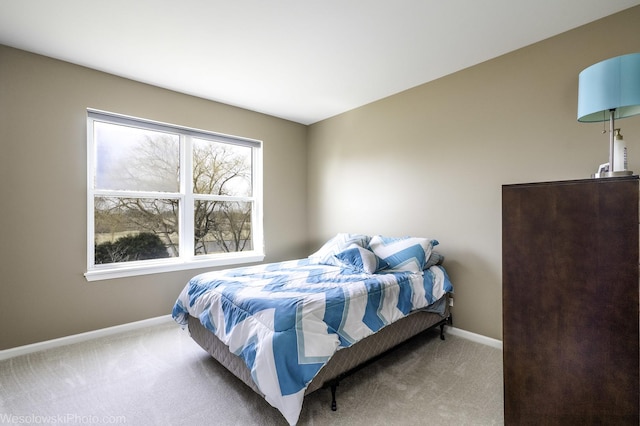 bedroom featuring carpet flooring and baseboards