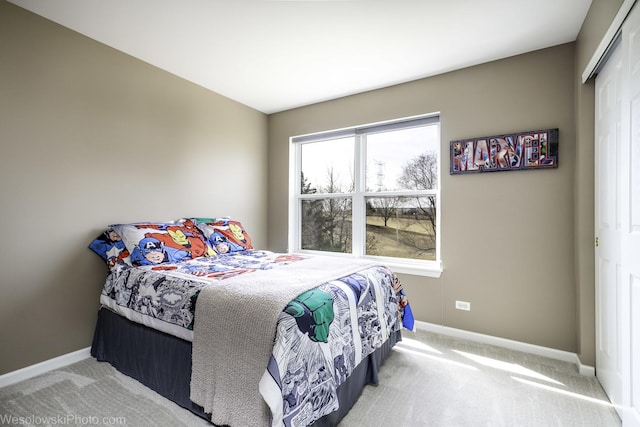 bedroom with a closet, baseboards, and carpet floors