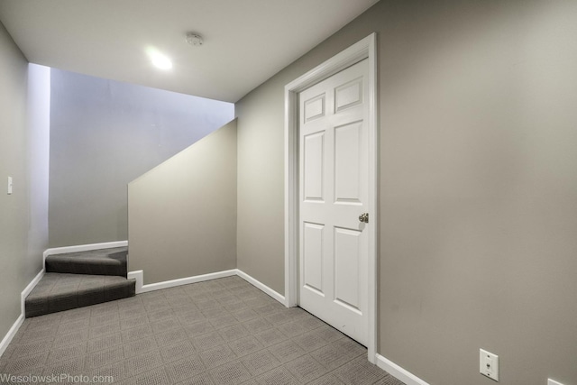 interior space with stairway, carpet, and baseboards