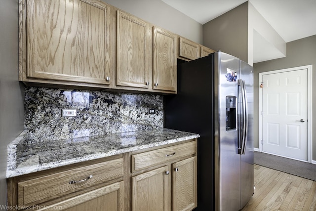 kitchen featuring light wood-style floors, tasteful backsplash, light brown cabinets, and stainless steel refrigerator with ice dispenser