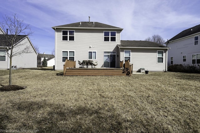 rear view of house with a lawn and a deck