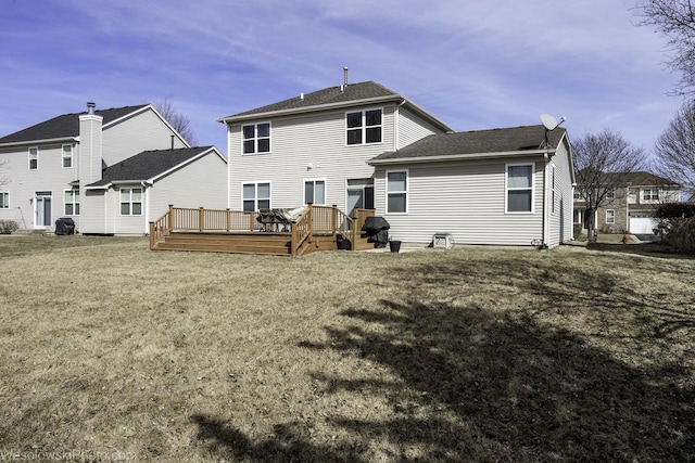 rear view of property featuring a wooden deck and a yard