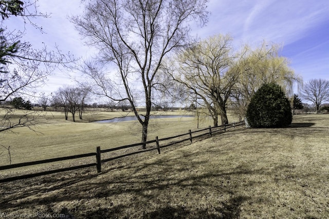 view of yard featuring a rural view and fence