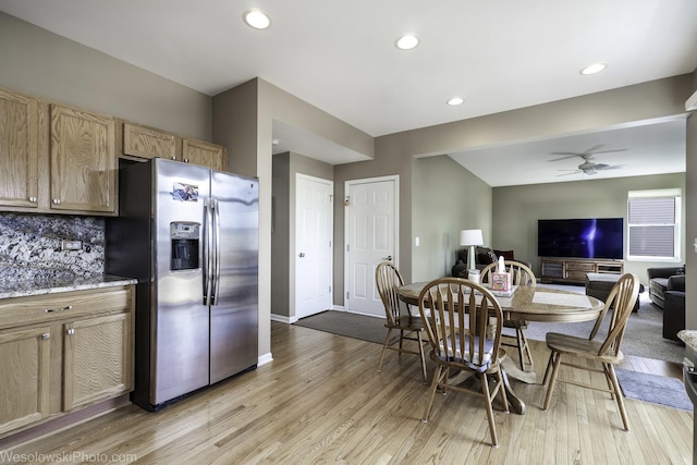 kitchen featuring a ceiling fan, light wood-style floors, open floor plan, and stainless steel fridge with ice dispenser