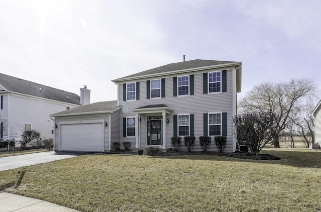 colonial inspired home featuring a garage, a front yard, and driveway