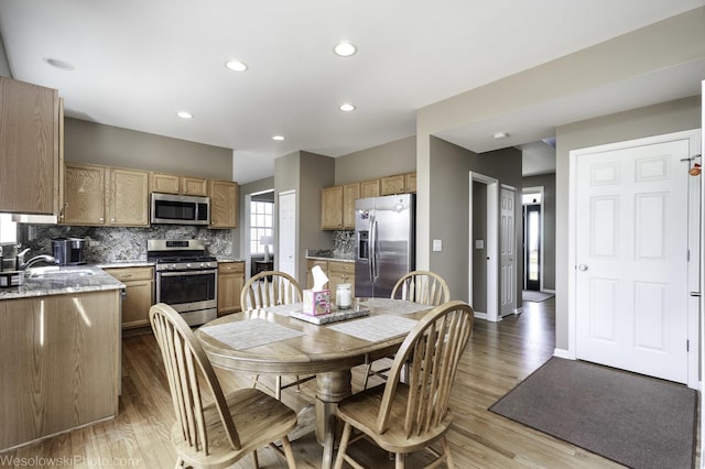 dining area with recessed lighting, baseboards, and wood finished floors