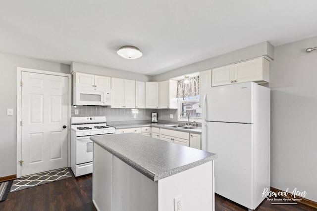 kitchen featuring white appliances, backsplash, a sink, and white cabinets