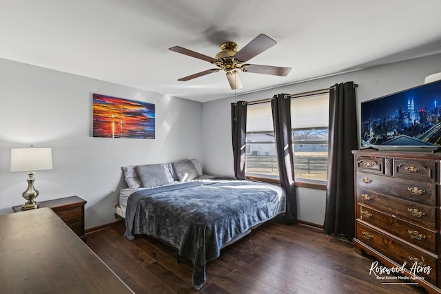 bedroom with ceiling fan, baseboards, and hardwood / wood-style flooring