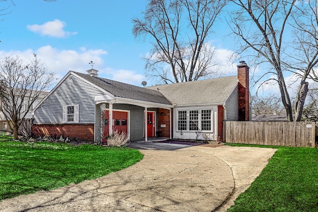 view of front of home with a garage, a chimney, fence, a front lawn, and brick siding