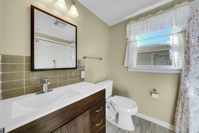 full bath featuring visible vents, toilet, decorative backsplash, vanity, and wood finished floors