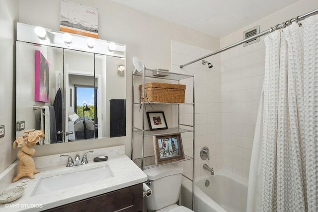 bathroom featuring toilet, shower / bath combo, and vanity