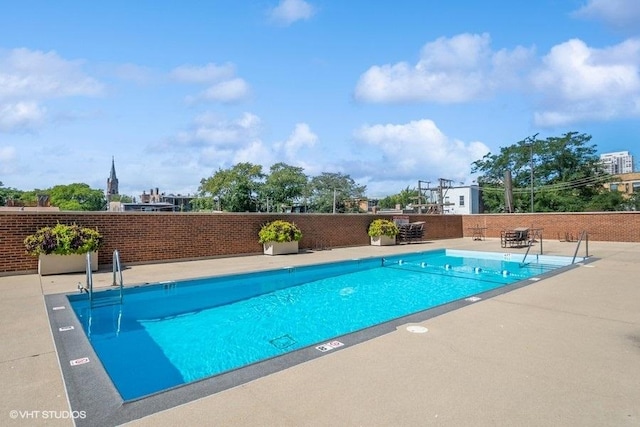 pool featuring a patio and fence