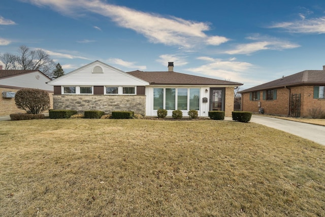 ranch-style house featuring stone siding, a front lawn, a chimney, and driveway