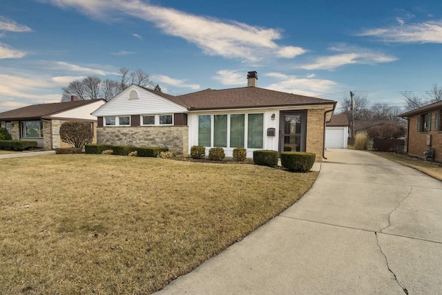 view of front of home with a garage, stone siding, a chimney, an outdoor structure, and a front lawn