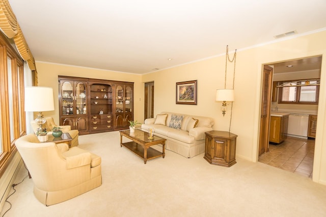 carpeted living room with visible vents, crown molding, and tile patterned floors