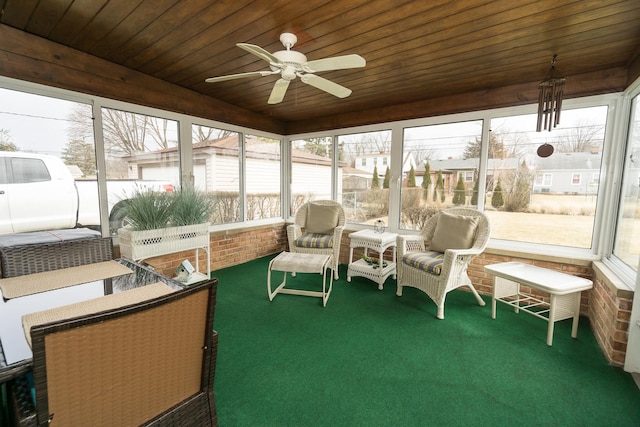 sunroom featuring wooden ceiling and a ceiling fan