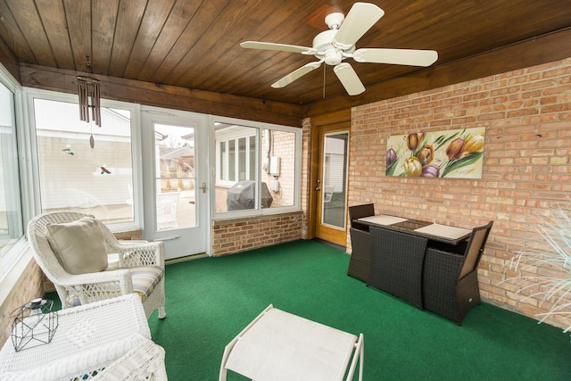 sunroom / solarium featuring wooden ceiling and a ceiling fan