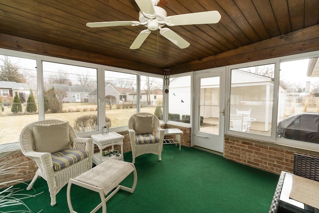 sunroom with ceiling fan, wooden ceiling, and a residential view