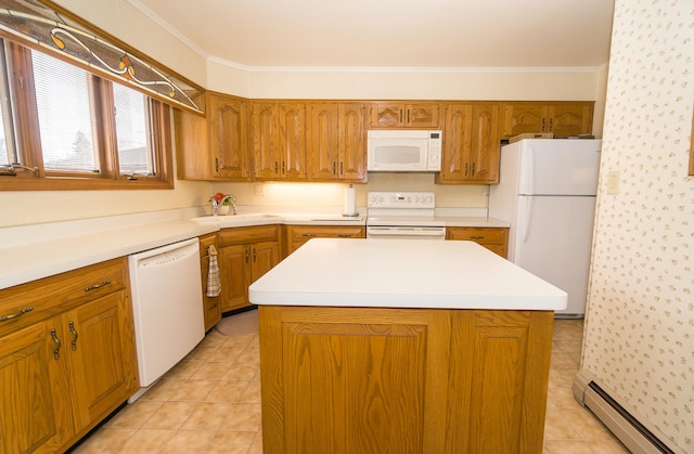 kitchen with brown cabinets, crown molding, a baseboard heating unit, a sink, and white appliances