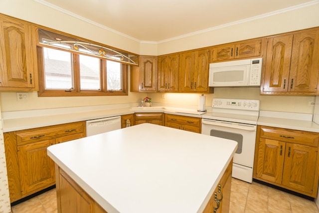 kitchen with a center island, light countertops, brown cabinetry, ornamental molding, and white appliances