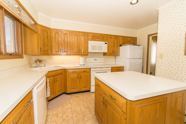 kitchen with ornamental molding, white appliances, light countertops, and a sink