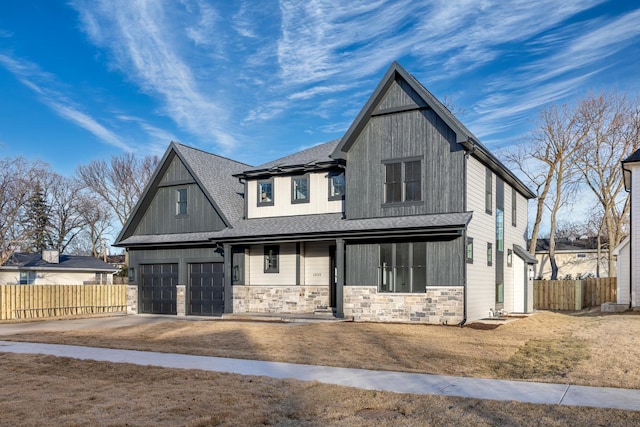 modern farmhouse featuring driveway, stone siding, fence, and a porch