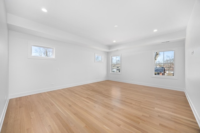 unfurnished room with recessed lighting, baseboards, plenty of natural light, and light wood finished floors