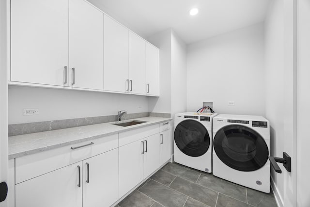 laundry room featuring recessed lighting, cabinet space, a sink, separate washer and dryer, and dark tile patterned flooring