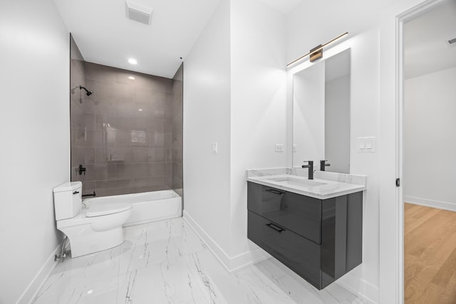 bathroom featuring marble finish floor, vanity, toilet, and baseboards