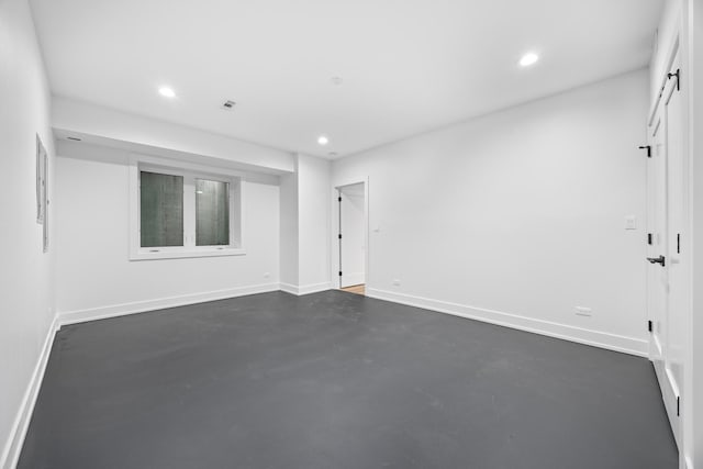 unfurnished room featuring visible vents, finished concrete floors, baseboards, and recessed lighting