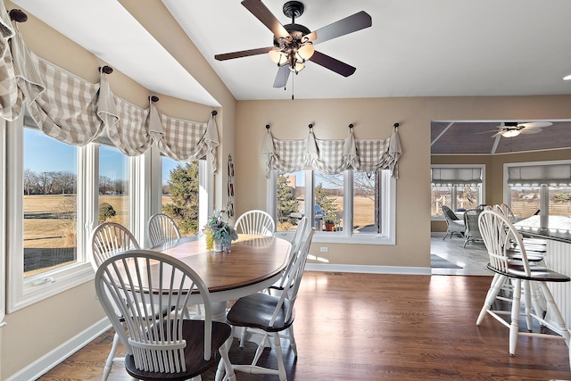 dining area with plenty of natural light, baseboards, and wood finished floors