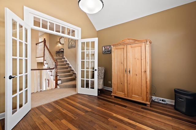 interior space with high vaulted ceiling, dark wood-style floors, french doors, baseboards, and stairs