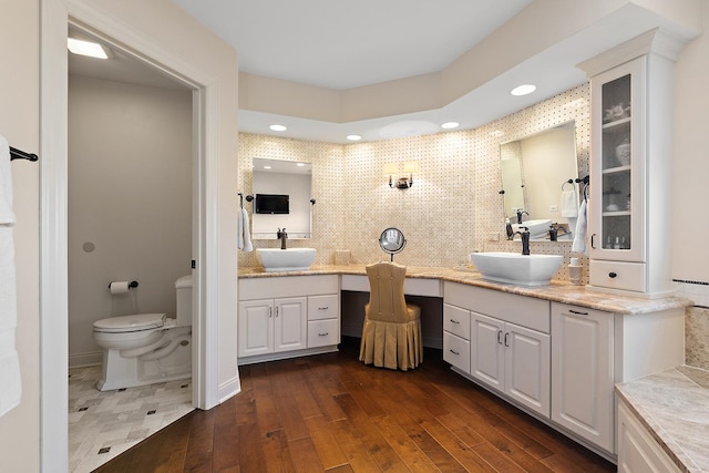 full bathroom with tasteful backsplash, toilet, recessed lighting, hardwood / wood-style flooring, and vanity