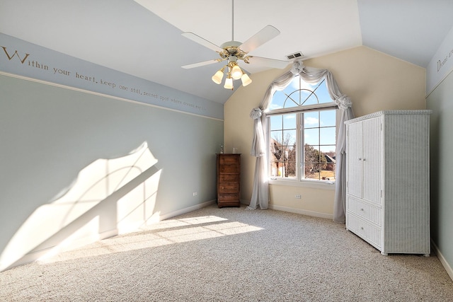 unfurnished bedroom featuring visible vents, baseboards, lofted ceiling, and carpet floors