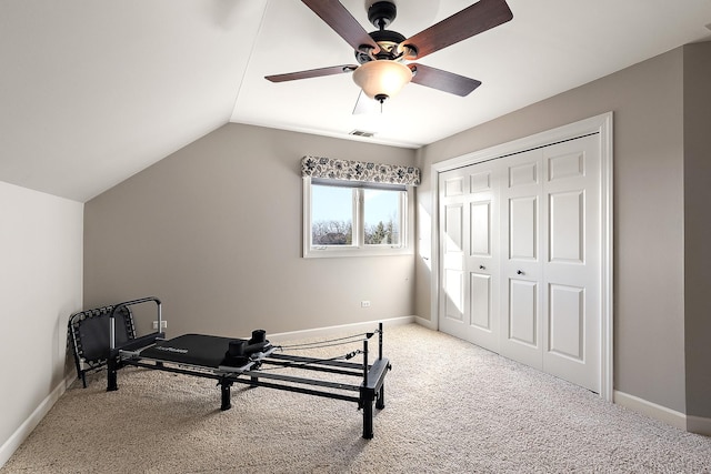 workout room with visible vents, light carpet, baseboards, and vaulted ceiling