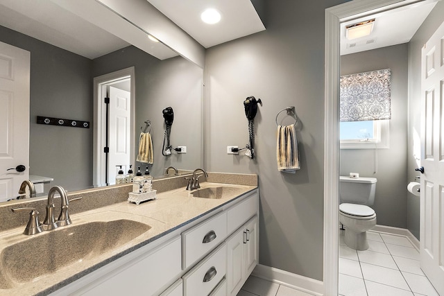 full bath featuring tile patterned floors, toilet, baseboards, and a sink