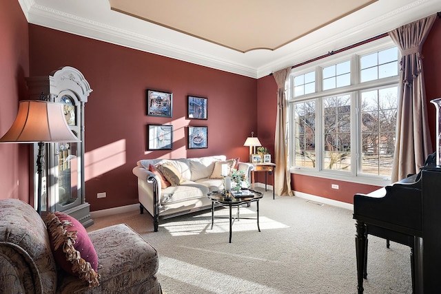 living room with visible vents, baseboards, ornamental molding, and carpet flooring