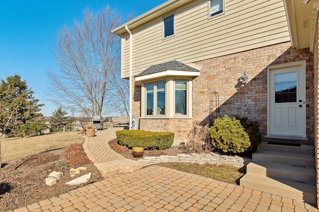 exterior space with a patio and brick siding