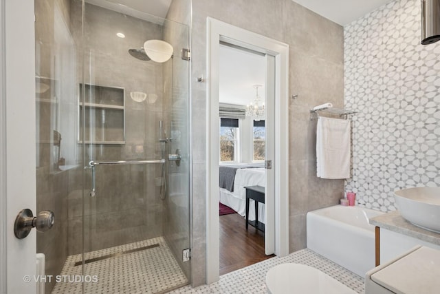 ensuite bathroom featuring ensuite bathroom, vanity, a shower stall, and tile patterned flooring