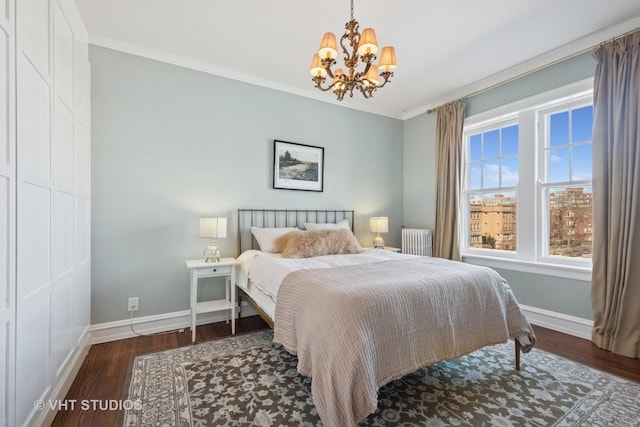 bedroom with radiator, wood finished floors, baseboards, ornamental molding, and a chandelier