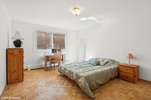 bedroom with a baseboard heating unit and baseboards