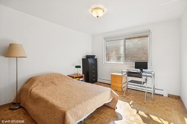 bedroom featuring a baseboard heating unit and baseboards