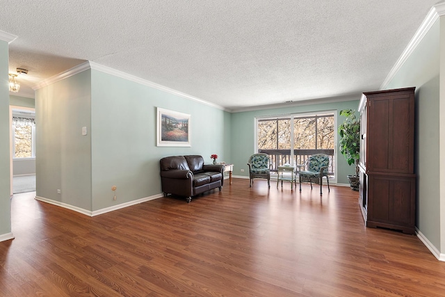 living area featuring a wealth of natural light, crown molding, and wood finished floors