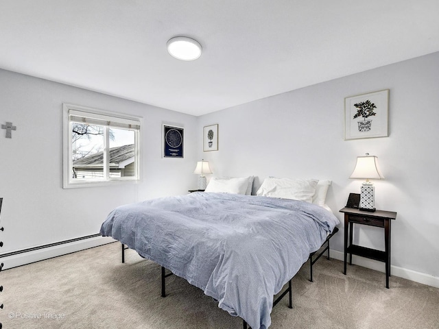 carpeted bedroom featuring baseboard heating and baseboards