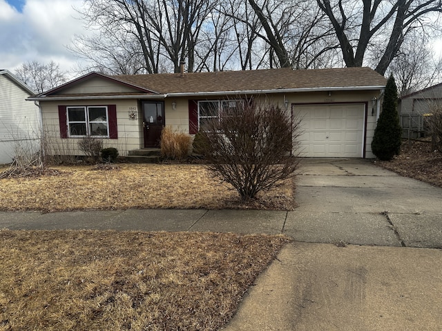 single story home featuring a garage and driveway