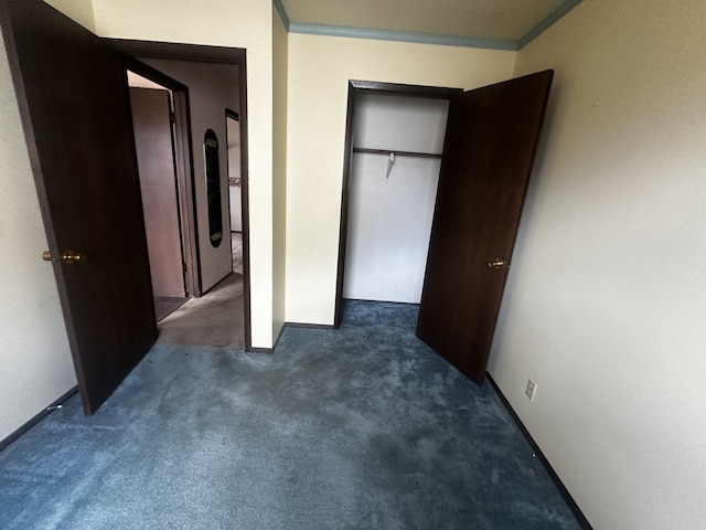 unfurnished bedroom featuring ornamental molding and carpet flooring