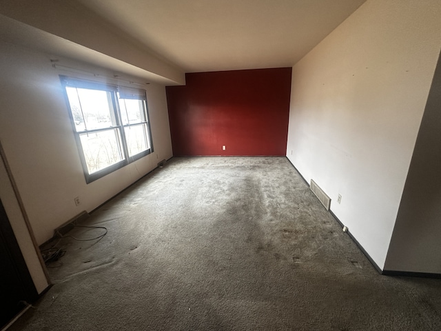 carpeted empty room with visible vents