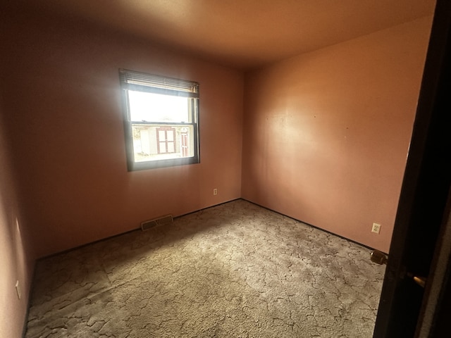 carpeted spare room with visible vents