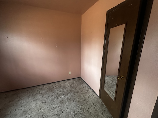 unfurnished room featuring carpet